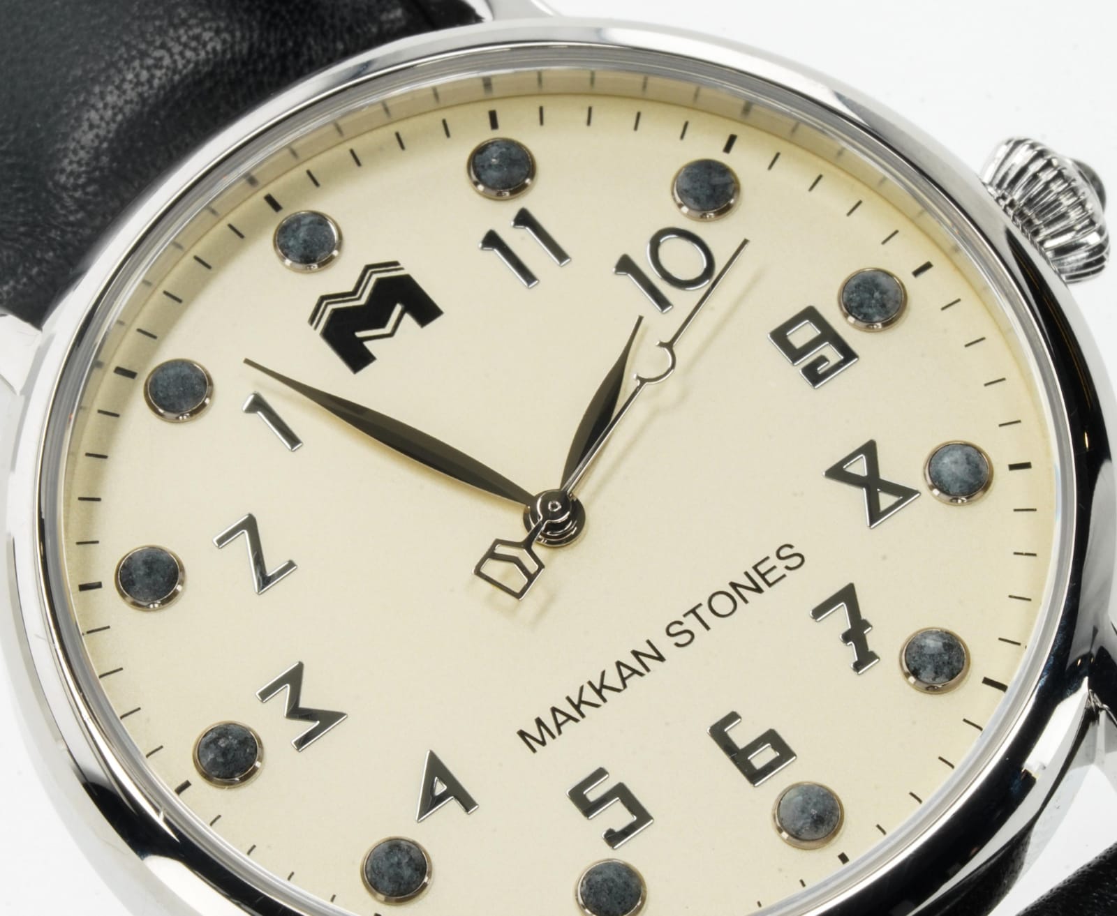 Macro of the Tawaf dial: cream face, steel case, Al-Khwarizmi numerals running anticlockwise