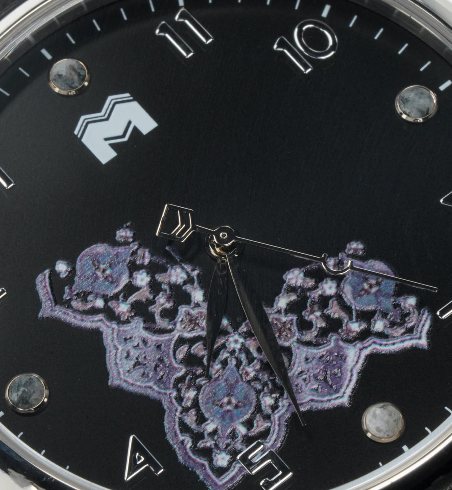 Macro of the Qur'an Frame dial: illuminated manuscript border on black
