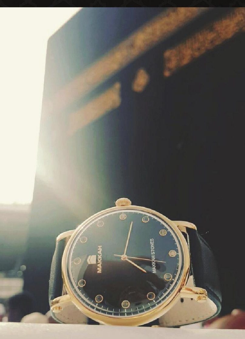 The Makkah watch resting before the Holy Kaaba at golden hour