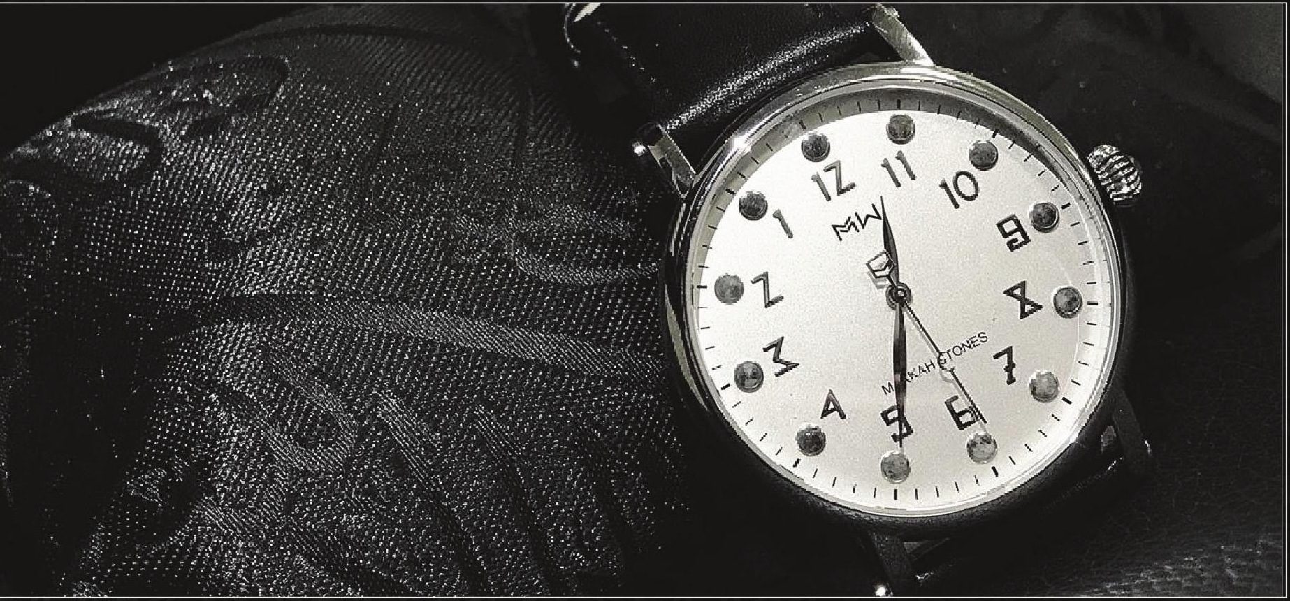 The Tawaf watch resting on dark embroidered cloth